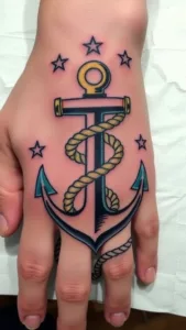 Anchor tattoo on hand with stars and rope design, showcasing nautical theme and intricate artwork.