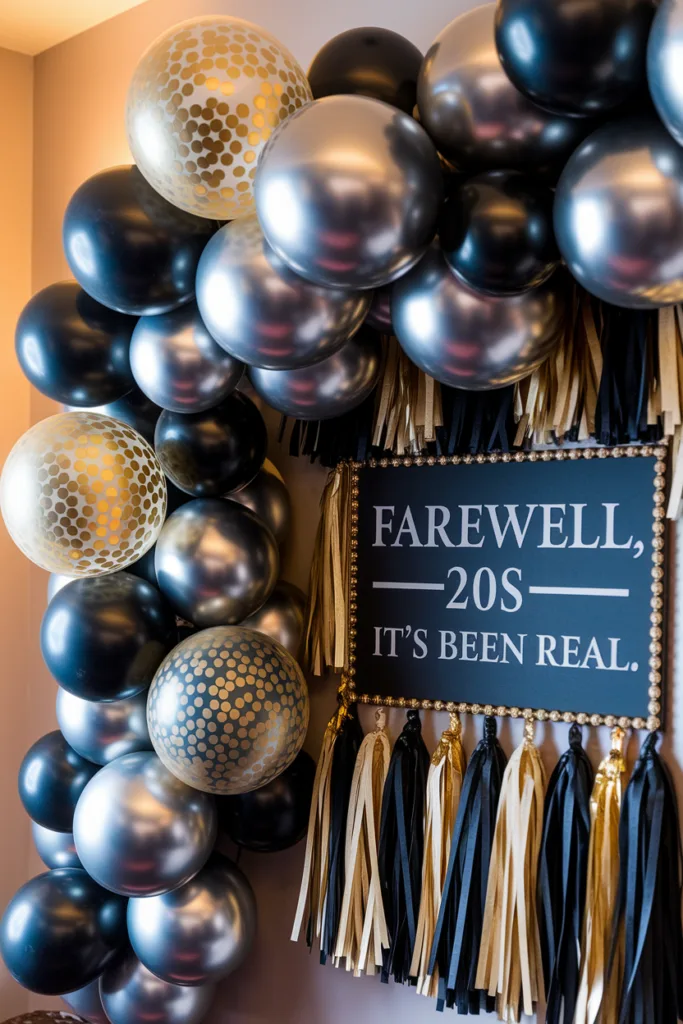 Farewell 20s party decor with gold, black balloons and tassels, sign reads Farewell, 20s - It's Been Real.