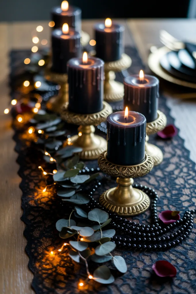 Elegant table setting with black candles, gold holders, lace runner, and string lights for a romantic ambiance.